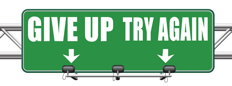 Road sign which points in different directions, "give up" and "try again"
